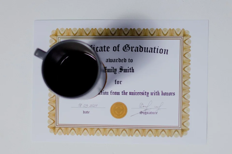 certificate of graduation with a cup of coffee on it