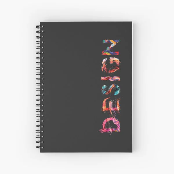 A spiral notebook with the word "Design" in paint.
