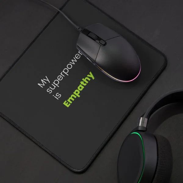 A mouse pad with the phrase "My Superpower is Empathy" in white and green letters.
