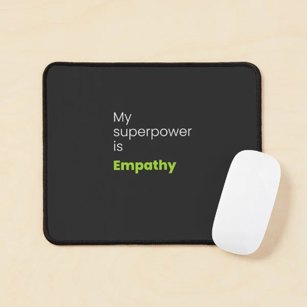 A mouse pad with the phrase "My superpower is empathy" in white and green letters.