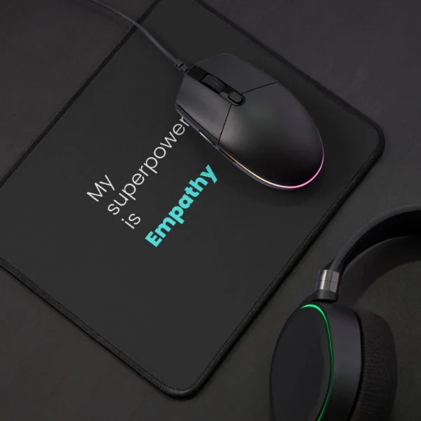 A turquoise mouse pad with the phrase "My superpower is empathy" in white and turquoise letters.