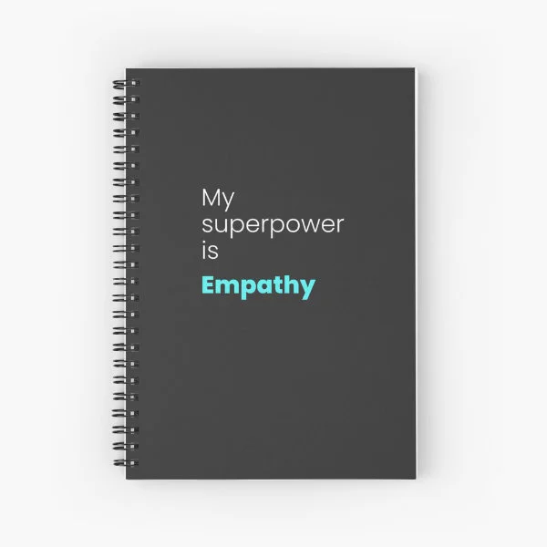 A spiral notebook with the phrase "My superpower is empathy" in white and turquoise letters.