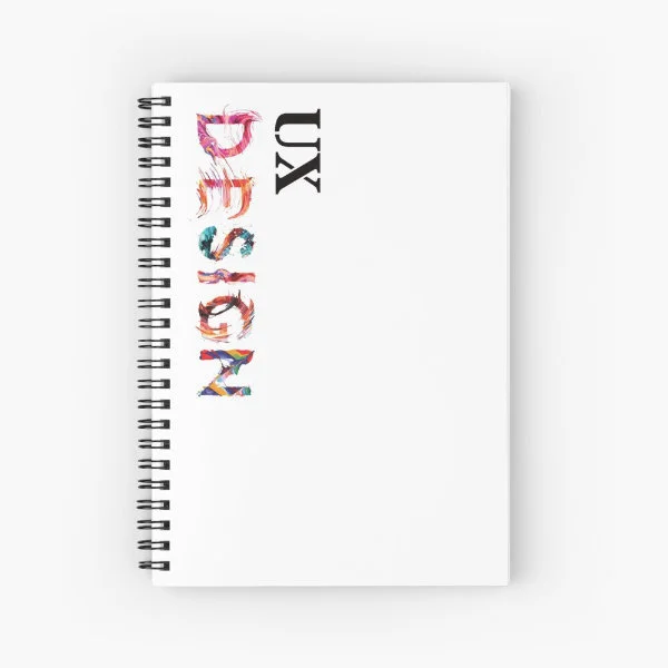 A spiral notebook with the words "UX Design" in paint.