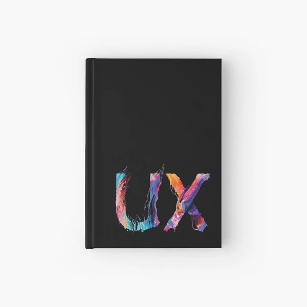 A hardcover journal with the letters "UX" in paint.