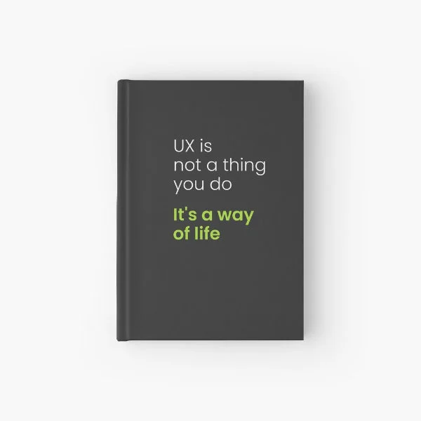 A hardcover journal with the phrase "UX is not a thing you do, it&rsquo;s a way of life" in white and green letters.